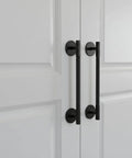 Matte Black Escutcheon Back Plates For Cabinet Knobs And Doors Four Pack Round Rosette Plate Two And One Third Inch Heavy Duty Die Cast Zinc Ideal For Bifold Closet Doors Door Pulls And Handles shown installed on white bifold doors
