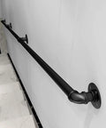 Straight Up Rock Solid Black Iron Railing For Indoor And Outdoor Use Adjustable Height Safety Guardrail With Rustproof Finish For Decks Patios And Staircase Installation mounted on a wall.