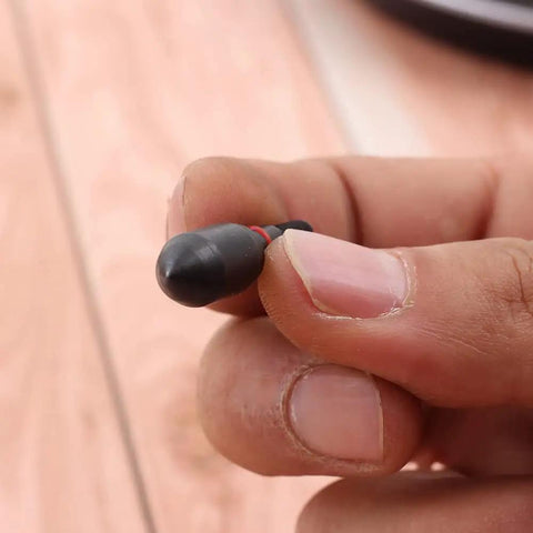 Close-up of 12 Pack Archery Field Points 100 And 125 Grain Screw In Arrow Tips with rubber O-ring, held between fingers