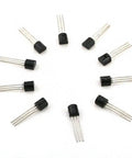 Top view of multiple black and silver transistors arranged in a circle from the 675 Piece Power Transistor Kit Assortment With 15 Models