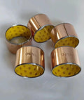 Single SF-2 Self Lubricating Copper Bushing 80 By 85 By 50 Mm Oilless Composite Wrapped Bearing in a group of five.