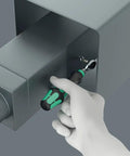Hand using Zyklop Mini 4 Bit Ratchet One Quarter Inch Drive Fifty Millimeter Hex Bit Holder for precise fastening in tight space