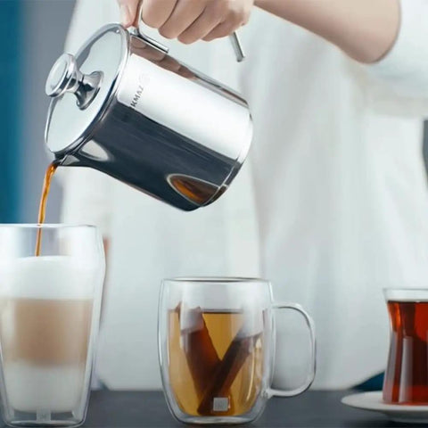 Aqua Turkish Teapot Set In Eighteen Ten Stainless Steel With Double French Press in use pouring coffee into glass mugs.