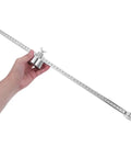 Hand holding Portable Torch Circle Cutting Guide Roller Wheel Compass for Oxyacetylene and Plasma Torches, metal tool for precise cuts.