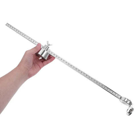 Hand holding Portable Torch Circle Cutting Guide Roller Wheel Compass for Oxyacetylene and Plasma Torches, metal tool for precise cuts.