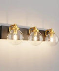 Industrial Black And Gold Vanity Light Fixture 3 Light Over Mirror Bath Wall Sconce With Clear Globe Glass Shades on wall