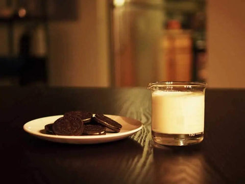 Lab Beaker Rocks Glasses Set Of 2 For Cocktails And Science Themed Barware with milk next to cookies on a dark table.