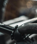 Close-up of hand adjusting crank preload ring for bottom bracket alignment on a bike, using durable aluminum tightening ring in black.