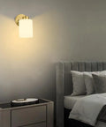 Bedroom view with Frosted Wall Sconce Set Of Two In Brushed Gold Modern Sleek Brass Vanity Lights illuminating the wall.