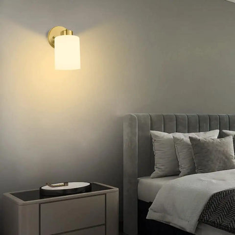 Bedroom view with Frosted Wall Sconce Set Of Two In Brushed Gold Modern Sleek Brass Vanity Lights illuminating the wall.