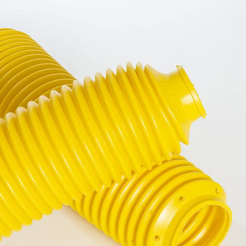 Hella Heavy Duty Yellow Fork Bellows Rubber Suspension Boot in close-up, showcasing ribbed design for offroad protection.