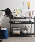 Top Shelf Iron Industrial Bookshelf Featuring a Sleek Narrow Frame showcasing decor and plants in a modern living room.