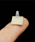 High Tack Adhesive PCB Standoffs With Snap Lock Posts For Circuit Boards Killer Grip Stick On Spacers For Screw Mounting, visible on finger.