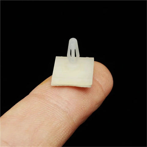 High Tack Adhesive PCB Standoffs With Snap Lock Posts For Circuit Boards Killer Grip Stick On Spacers For Screw Mounting, visible on finger.