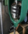Close-up of Rock Solid Portable Drill Press Square Tenon Converter, showing heavy steel housing and precision drilling components.