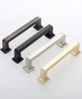 Four metal cabinet handles in black, silver, gold, and copper finishes, showcasing modern design and durable construction.