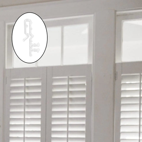 High Quality 16 Piece 2 Inch Clear Plastic Hidden Blind Valance Clips Made For A Dead Simple Install With Zero Drilling To Keep Your Window Coverings Snug And Stylish displayed next to white shutter blinds.