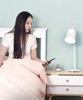 Person using Phone As Key Keyless Smart Drawer Lock For File Cabinets Desks Bookcases And Nightstands App Unlock on bed