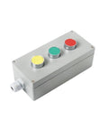 Gray metal push-button control box with three colored buttons (red, green, yellow) and a side cable gland.