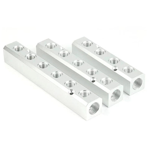 Three aluminum two-way pneumatic manifold blocks with multiple threaded ports, G1/2 inlet and G1/4 outlets.