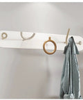 Heavy Duty Wrought Iron Wall Coat Hooks With Zero Hassle Setup For Bedroom And Entryway Modern Five Arm Rack hanging a robe.