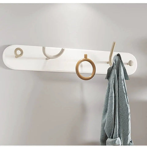 Heavy Duty Wrought Iron Wall Coat Hooks With Zero Hassle Setup For Bedroom And Entryway Modern Five Arm Rack hanging a robe.