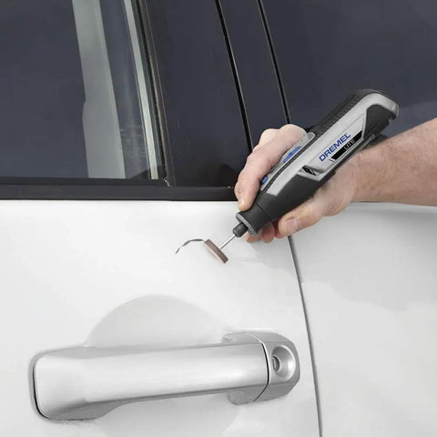 Hand using Totally Wireless Rotary Multi Tool With Super Cushioned Glove Grip and Killer 15 Piece Accessory Kit on car door