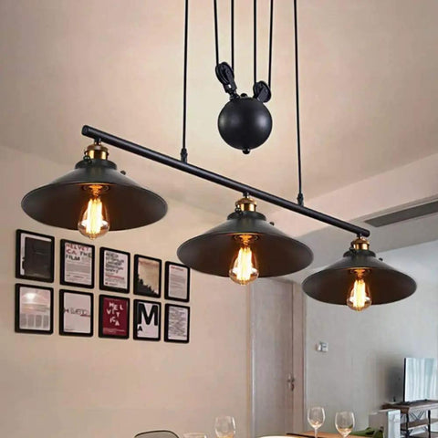 Fresh Vintage Industrial Billiard Chandelier Features Easily Adjustable Pulley Lift System In Classic Black Metal three light pendant lamp above dining table.
