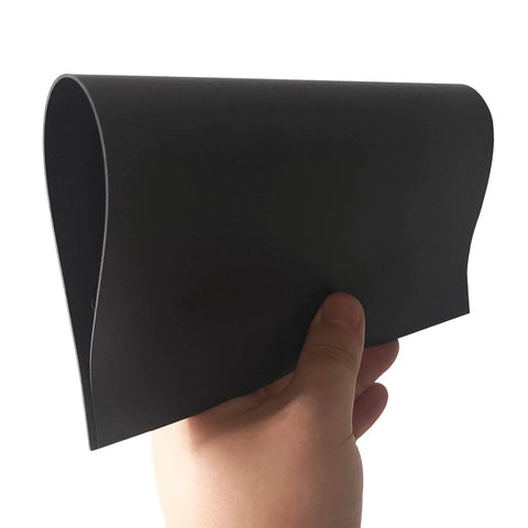 Person holding a non-adhesive magnetic sheet, flexible and 8.5 x 11 inches, showing material texture for crafts and DIY projects.