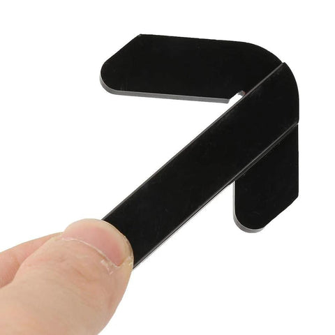 Close-up of black plastic center finder ruler held by hand for locating center of round workpieces on mini lathe/milling.