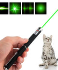 Three Pack Laser Pointer For Cats And Dogs Interactive Pet Toy Set With Red Green And Purple Lights Great For Playtime And Training Requires Two AAA Batteries Not Included shown in use with green laser light and a playful cat