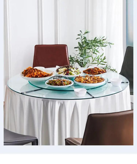 Super Smooth Tempered Glass Lazy Susan For Dining Table 360 Degrees Turntable with food on a round glass serving tray.