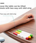 Close-up of rolling sit stand desk's anti-skid strip and colorful markers, showcasing ergonomic features and usability.