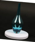 Stunning White Motorized Rotating Display Stand With Mirror Finish Turntable For Jewelry Watches Digital Gadgets And Collectibles 5Kg Capacity showcasing a blue glass vase.