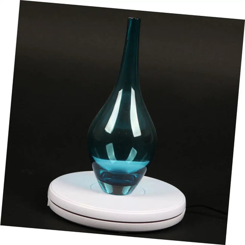 Stunning White Motorized Rotating Display Stand With Mirror Finish Turntable For Jewelry Watches Digital Gadgets And Collectibles 5Kg Capacity showcasing a blue glass vase.