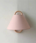 Wall Sconce Lights Indoor Bedroom Hallway Modern Fabric,Wood Ring E14 Lamp for with a pink fabric shade and wooden ring.