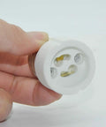 E26 E27 To GU10 Ceramic Socket Adapter Built Tough For Heavy Duty Halogen And Led Spotlight Work UL Certified 660 Watt, held in hand.