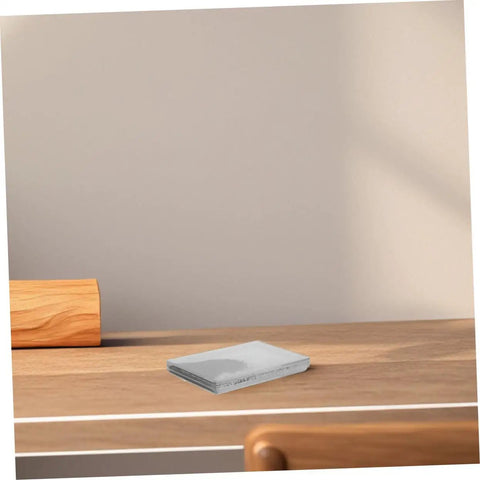 Folded white napkins on a wooden table with a light wall background