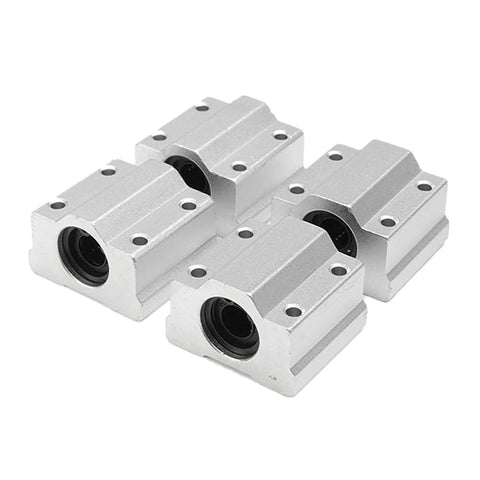 Set of four aluminum linear-rail bearing blocks with mounting holes, front-angle view