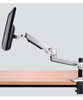 Slick Aluminum Desktop Clamp Monitor Mount For 17 To 32 Inch Screens With Smooth Full Motion Spring Arm on a desk.