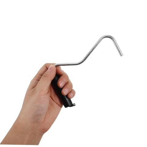 Hand holding a Tent Stake Puller Tool For Camping Peg Remover And Extractor, Lightweight Portable Design For Quick Setup.