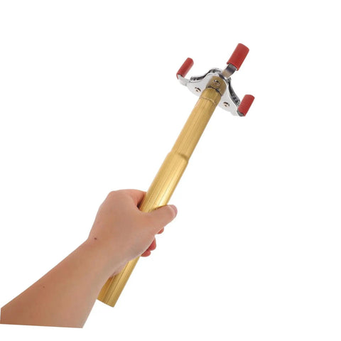 Smoke Sensor Removal Tool With Claw Head Attachment For Ceilings Hassle Free Fire Detector Extraction Safe For Delicate Alarms, held in hand.