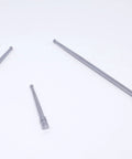 Three silver metal coaxial centering indicator rods with ball tips for milling machines