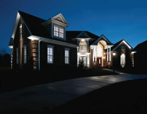Large house exterior illuminated at night, showcasing Two Light Hammered Glass Outdoor Hanging Lantern Textured Black Traditional Style Porch Light