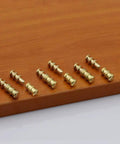 Zinc alloy table connector pins on wooden surface, 30x8mm, for snug extension leaf alignment, Upgrade Your Setup With This Set Of Fifteen Zinc Alloy Table Connector Pins And Copper Plated Sleeves Designed For Snug Extension Leaf Alignment And Keeps Your Dining Table Rock Steady Daily.