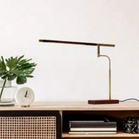 Barrett LED Desk Lamp with Dope Adjustable Walnut Wood Shade on modern desk, sleek design for home office or study space.