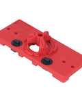 Red woodworking hinge drilling jig with 35mm hole guide and two black adjustment knobs.