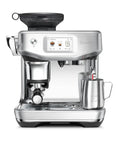Front view of Barista Touch Impress Espresso Machine With Real Time Guidance And Silky Microfoam Turbo 3 Second ThermoJet Heat Up Impress Puck System For Home Barista Quality Brews In Brushed Stainless Steel BES881BSS with milk frothing pitcher on tray.