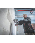 Professional Heavy Hitter 18V Brushless Cordless Hammer Drill Driver Set Includes Two 52Ah Lithium Ion Batteries Quick Charger used on wall.