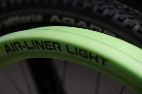 Close-up of green Air Liner Light XC Trail Mountain Bike Tire Insert for 29x2.1 to 2.4 inch tires showing branding.